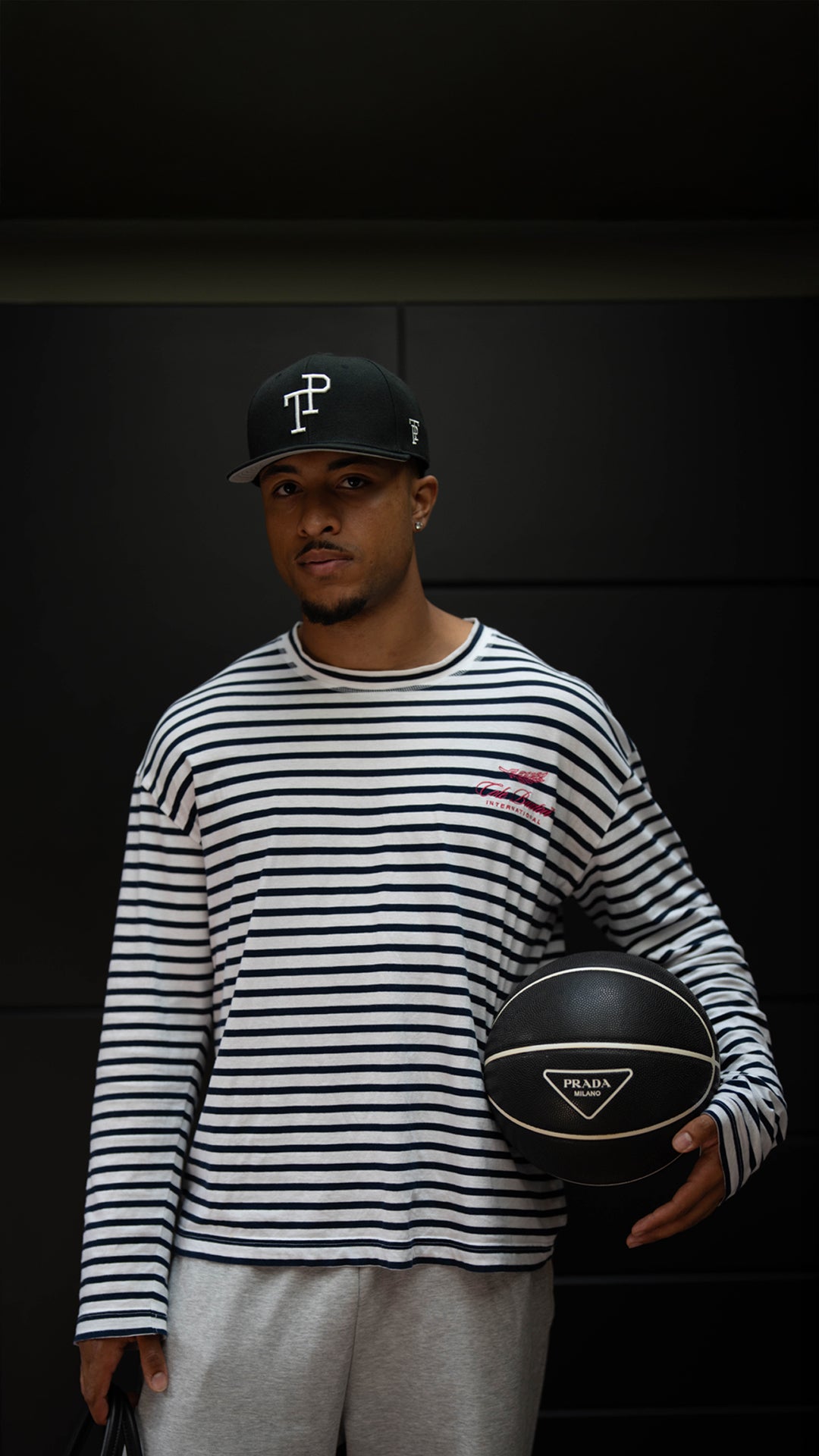 Dark green TP baseball cap with white embroidered logo resting on matte green Mercedes-Benz G-Wagon hood.