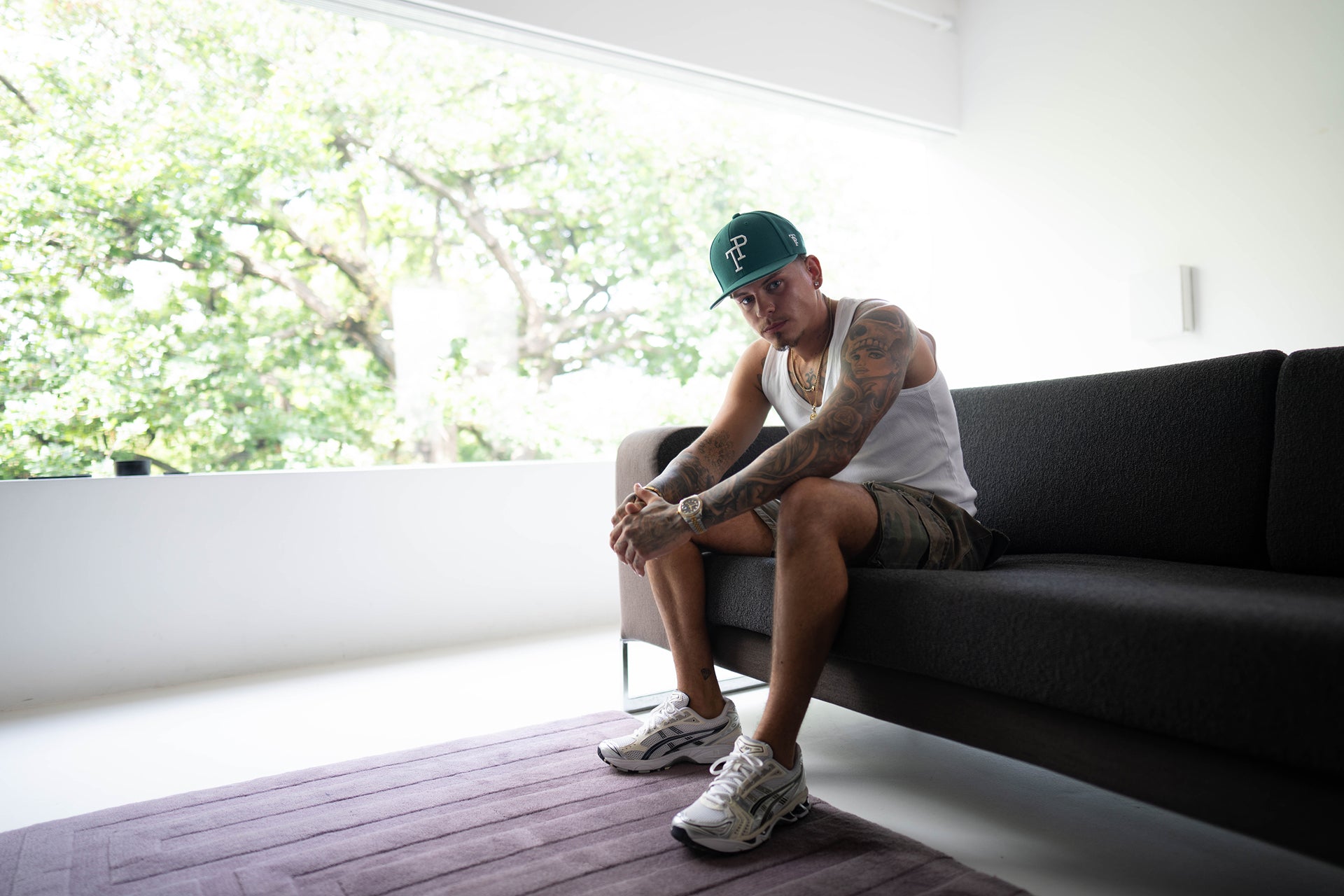 Dark green TP baseball cap with white embroidered logo resting on matte green Mercedes-Benz G-Wagon hood.